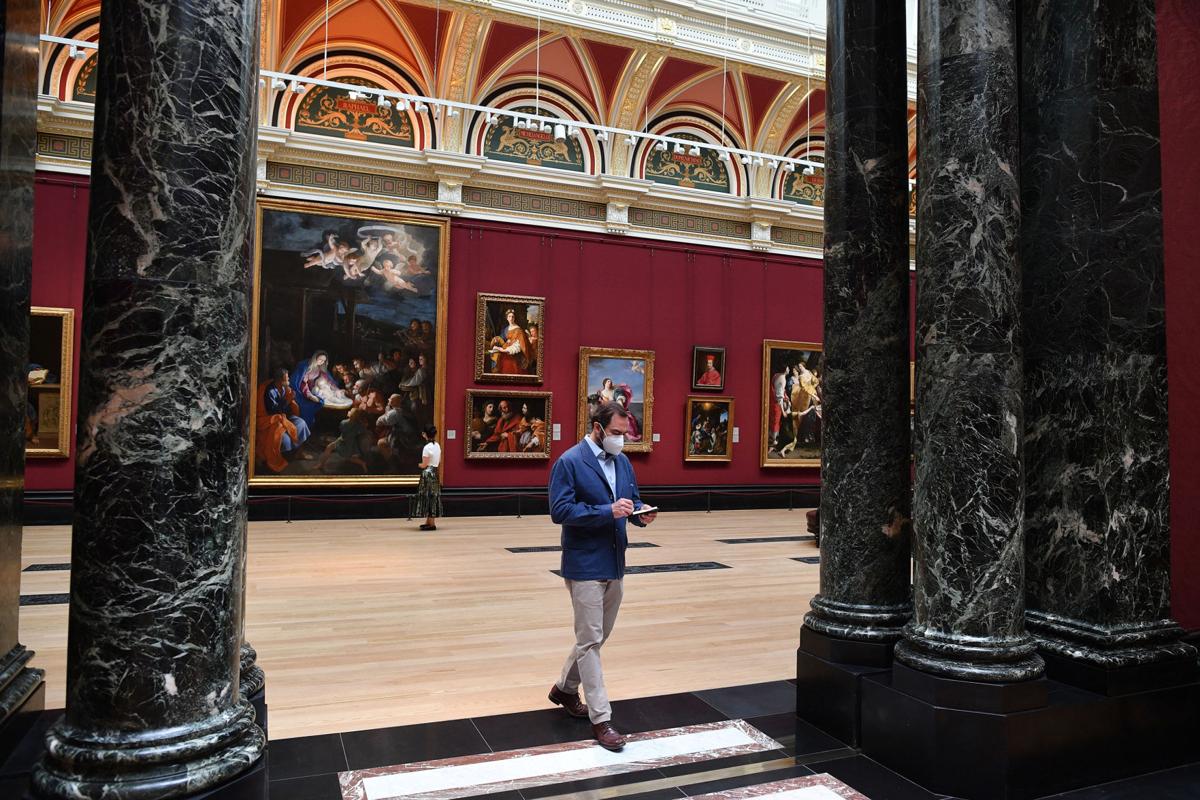 Members of staff and the media wearing protective face coverings move through a room inside the National Gallery on July 4, 2020, as the gallery prepares to reopen on July 8 following the easing of restrictions imposed during the novel coronavirus COVID-19 pandemic. English art galleries, museums and cinemas are able to open their doors from Saturday, July 4, as relaxations of the coronavirus restrictions continue.