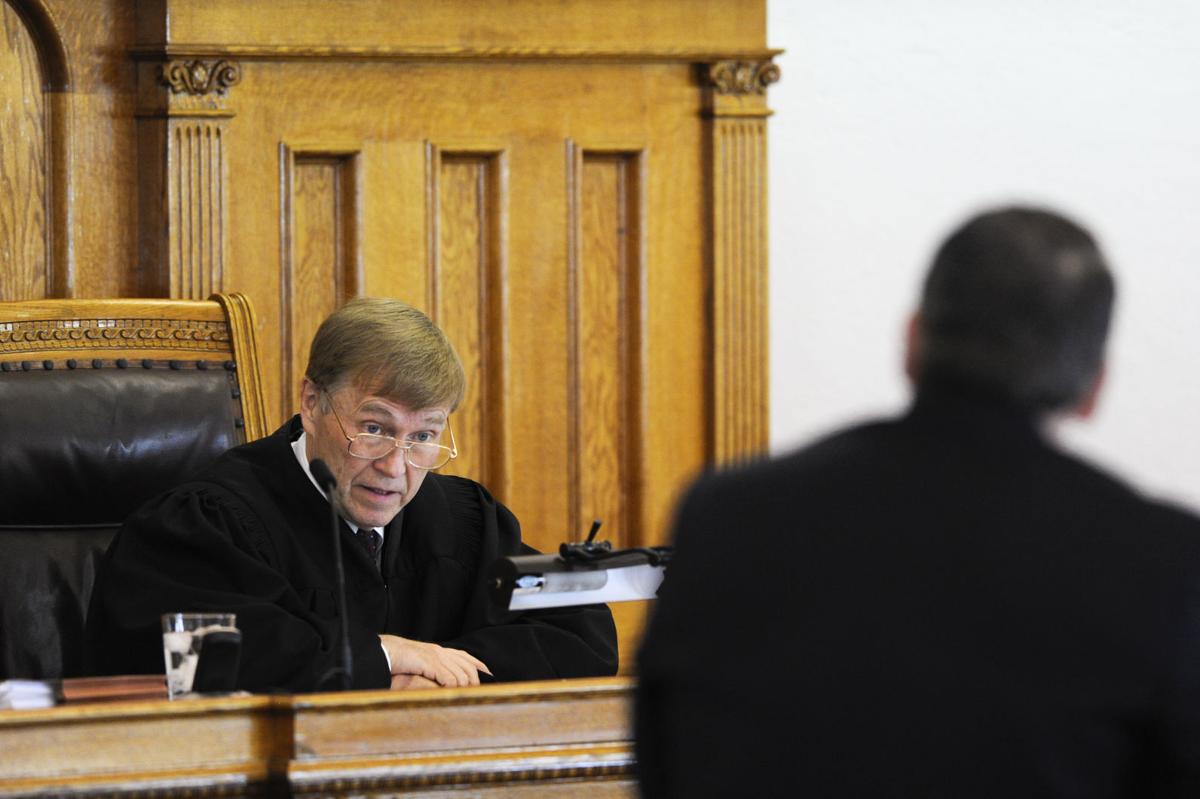 District Court Judge Ray Dayton, left, responds