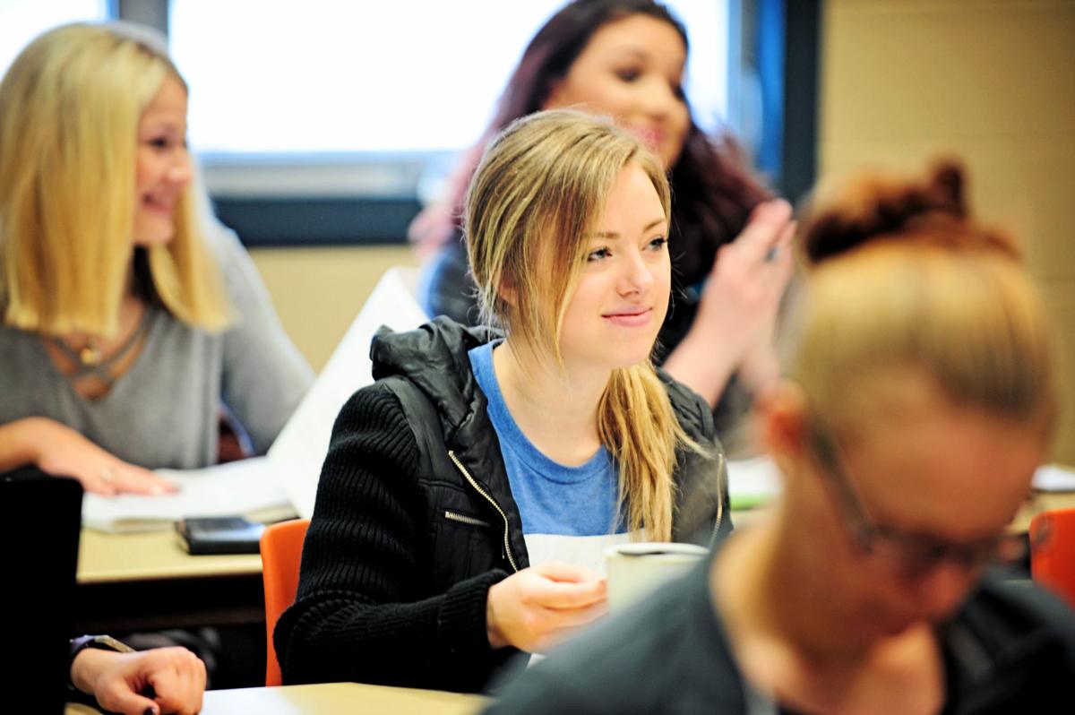 Students listen to a lecture at Helena College.
