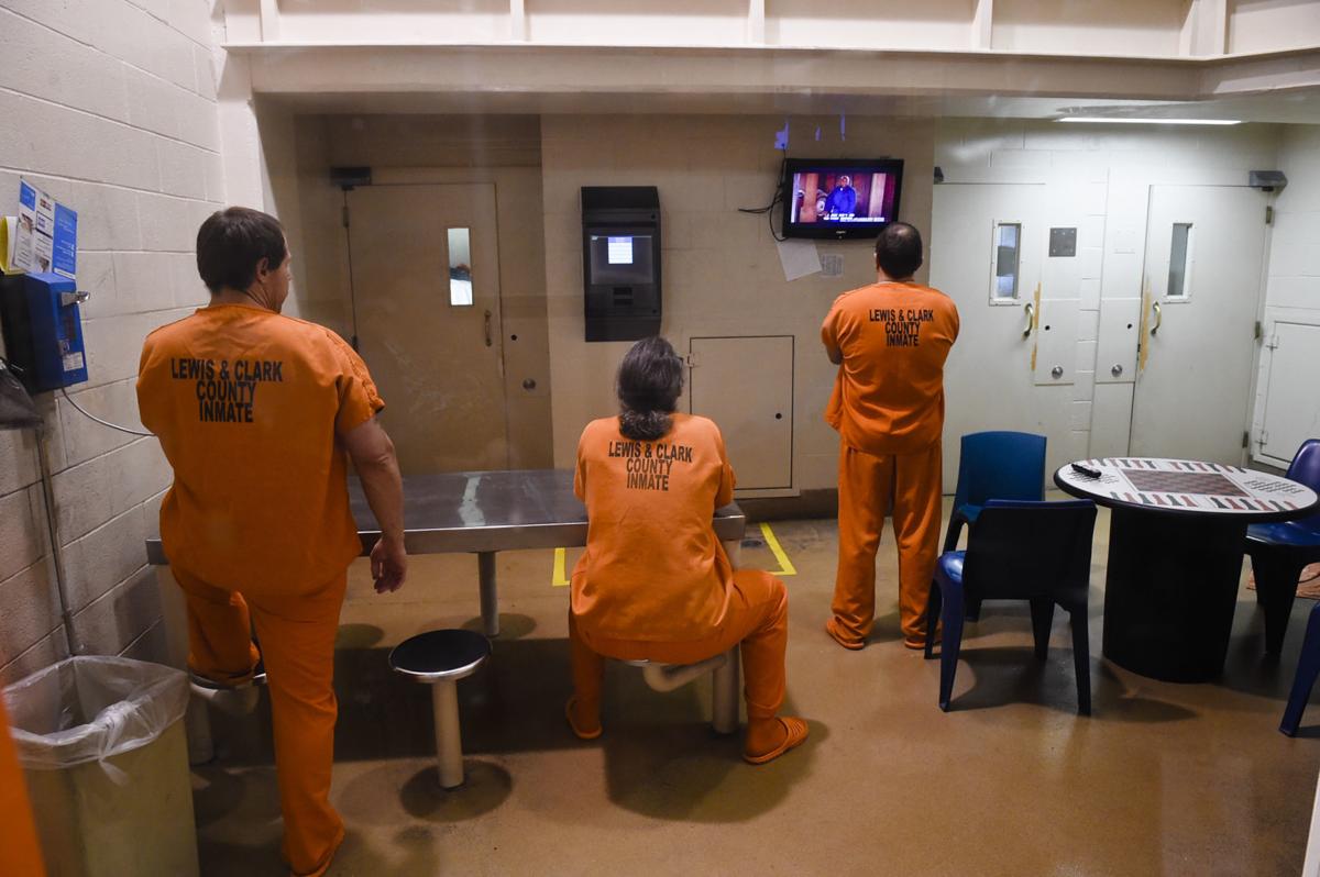 Inmates use the phone and watch television in the Lewis and Clark County Detention Center