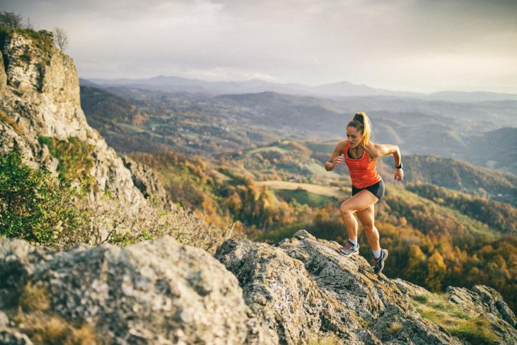 Young woman running on mountain