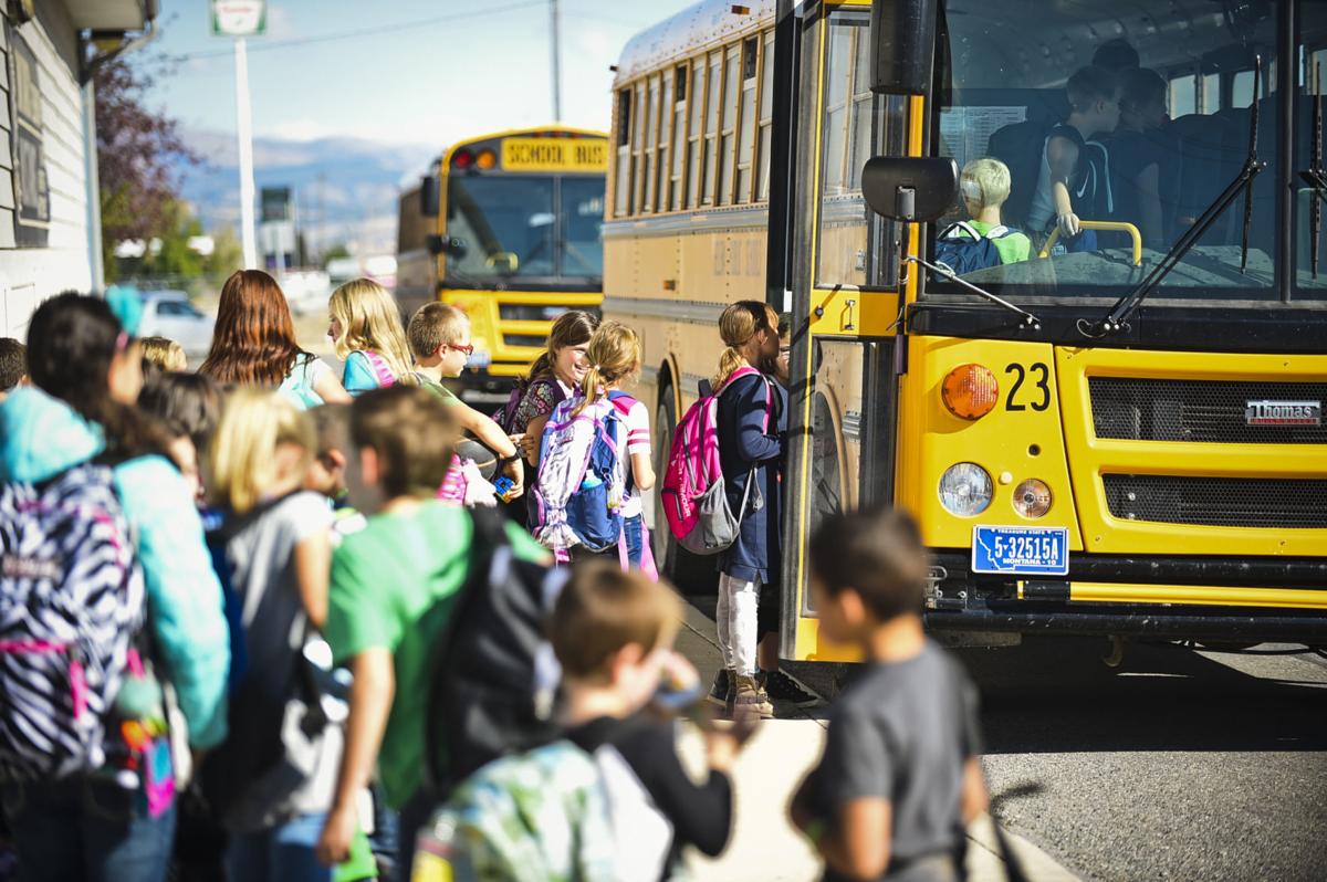 Students file onto a school bus