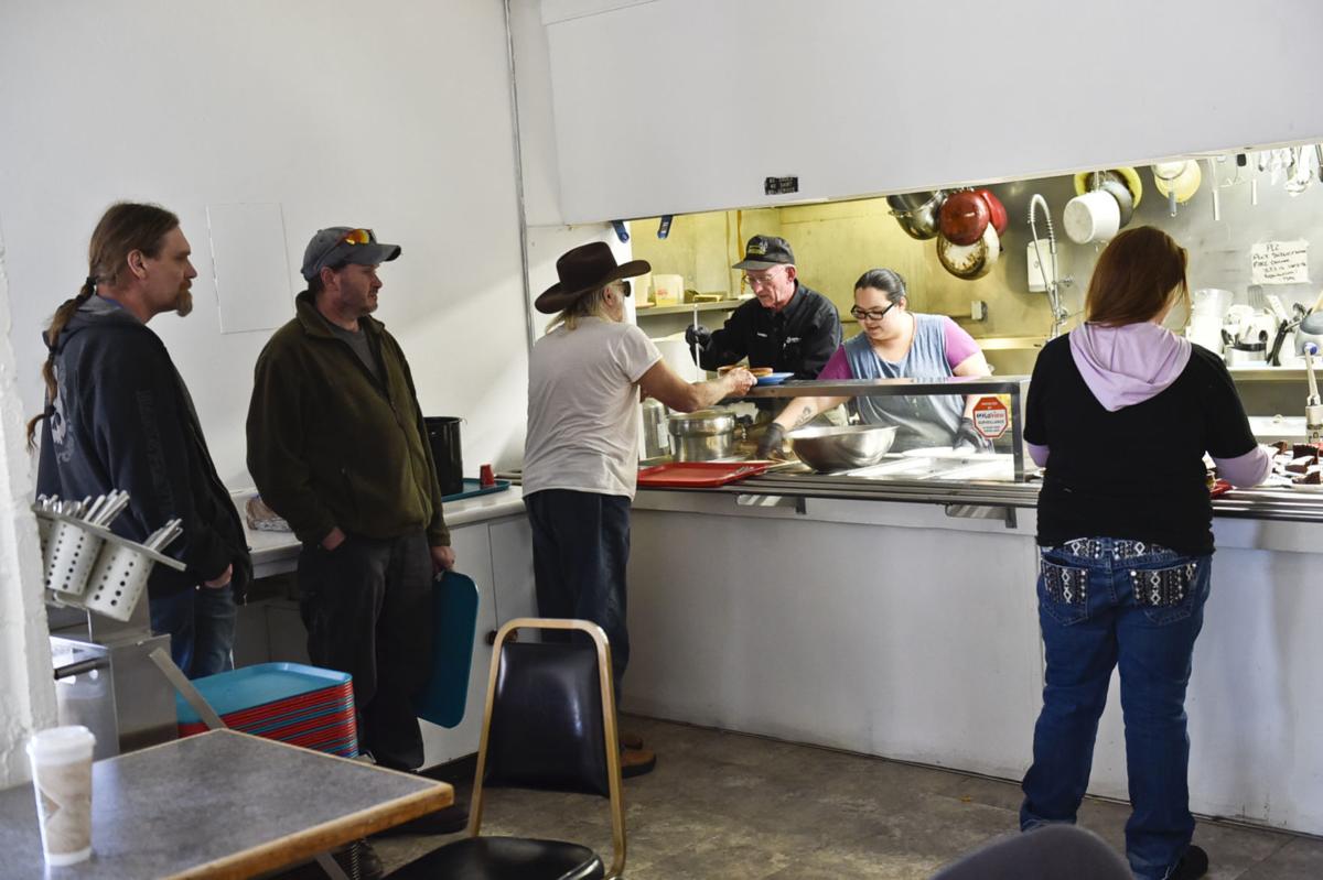 Volunteers serve lunch at God's Love April 17.