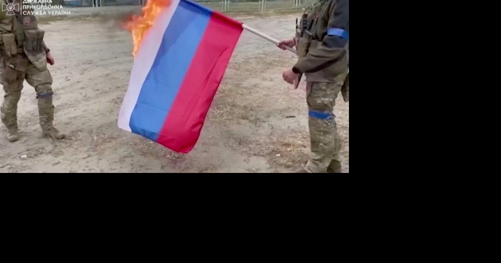 Ukrainian soldiers burn Russian flag as they reclaim territory