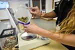 Rochelle Porter packages marijuana buds for a customer