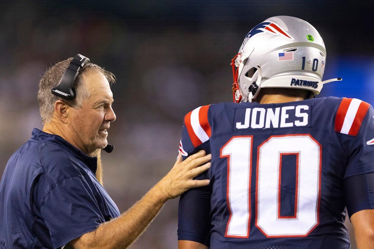 Head coach Bill Belichick of the New England Patriots talks to Mac Jones #10 against the Philadelphia Eagles in the first half of the preseason game at Lincoln Financial Field on Aug. 19, 2021 in Philadelphia, Pennsylvania.