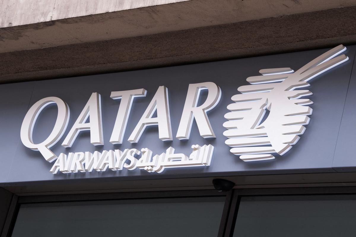 A shop sign of Qatar Airways on May 4, 2020 in Paris, France. The airline will now require passengers to wear a face shield in addition to a mask throughout their flight.