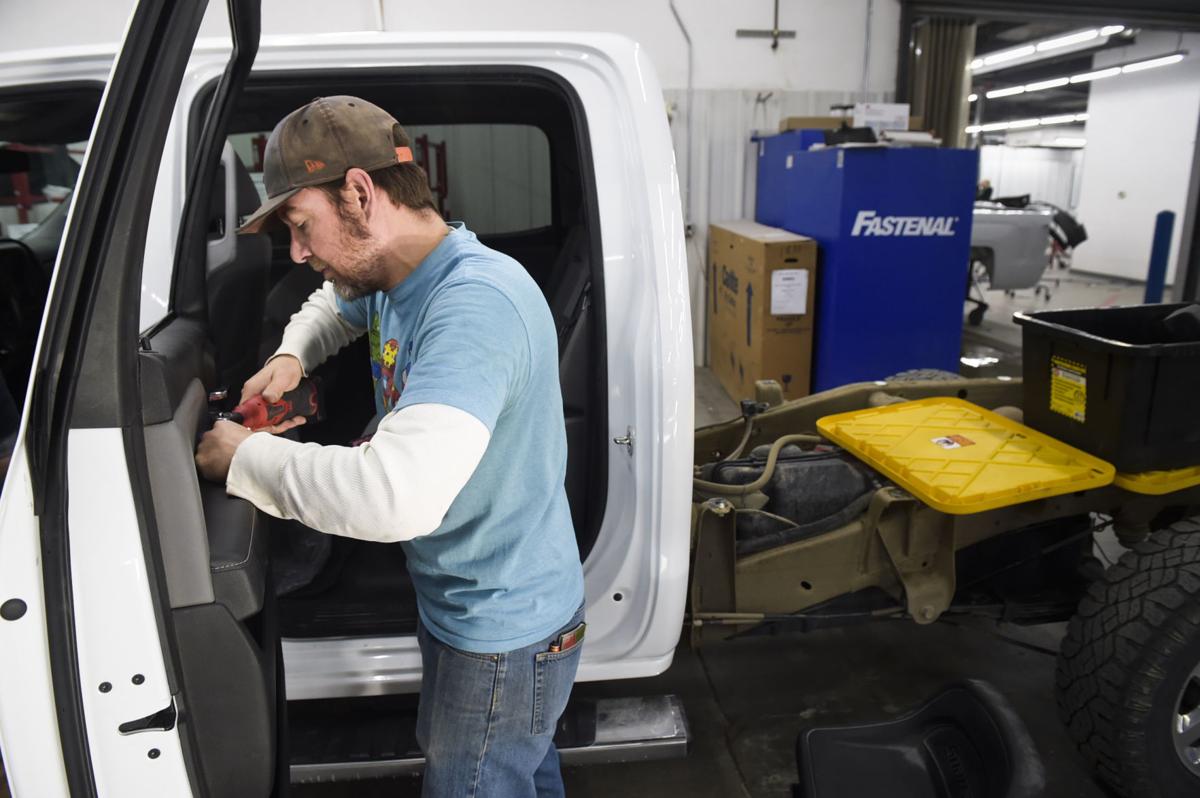 In this IR file photo, Jacob Nichols reassembles a truck at Collision Pro where he is one of a handful of apprentices receiving on-the-job training at the auto body shop.