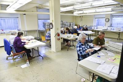 Election officials process voted ballots