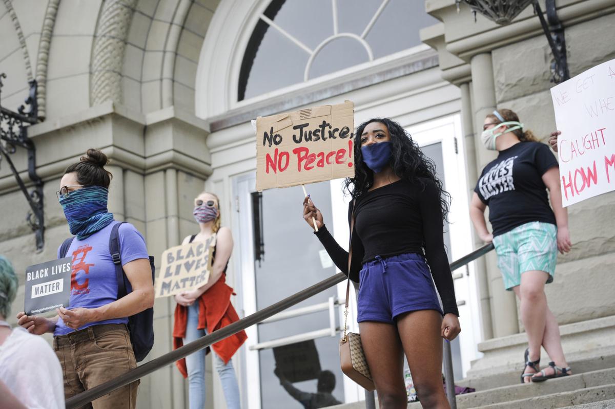 Protesters gather on the steps of the City-County Building Friday