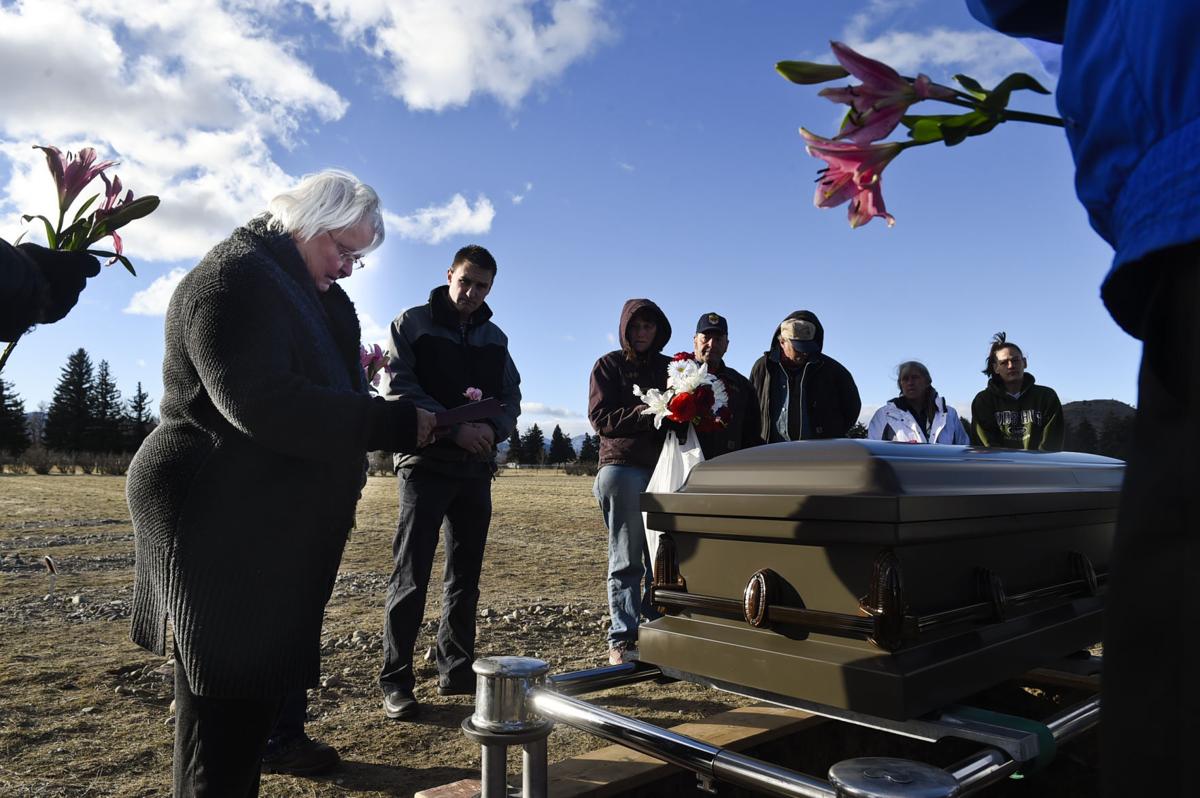 County commissioner Susan Good Geise, left, says a prayer during the funeral service last month.
