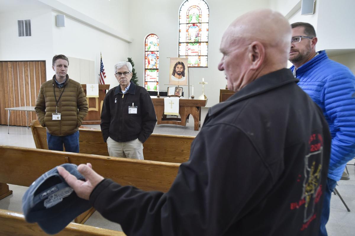Chief Deputy Attorney General Jon Bennion, left, and Lt. Gov. Mike Cooney, center, listen to Jefferson County Commissioner Leonard Wortman