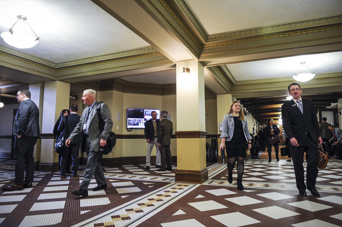 Lawmakers and lobbyists walk through the state capitol