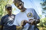 Volunteers Jennifer Fritz, right and Shane Sater remove a chickadee from a capture net