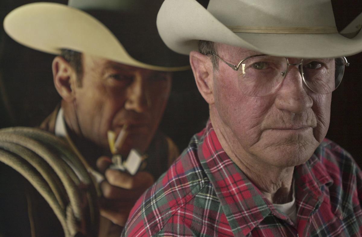 Cattle rancher W.Z. "Herf" Ingersoll , right, is photographed in front of his Marlboro Man billboard photo (IR copy)
