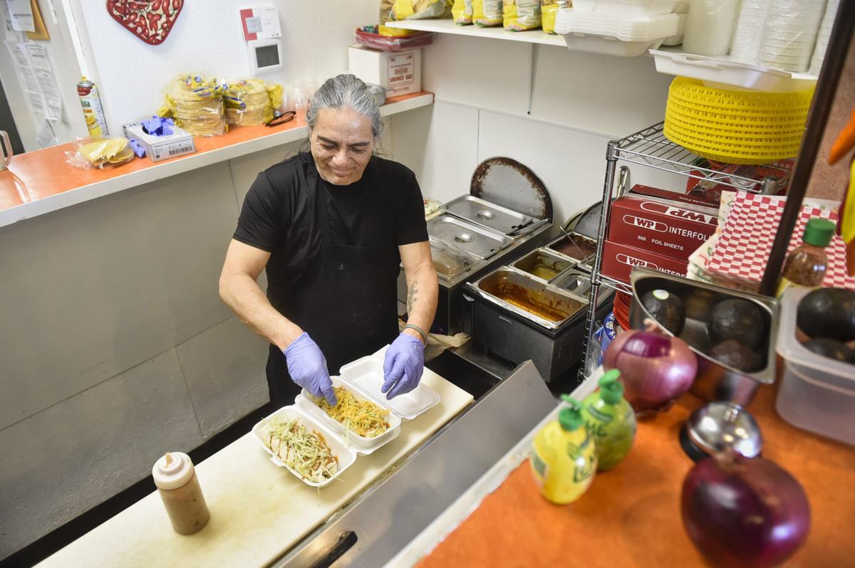 Louie Lopez prepares a couple burritos