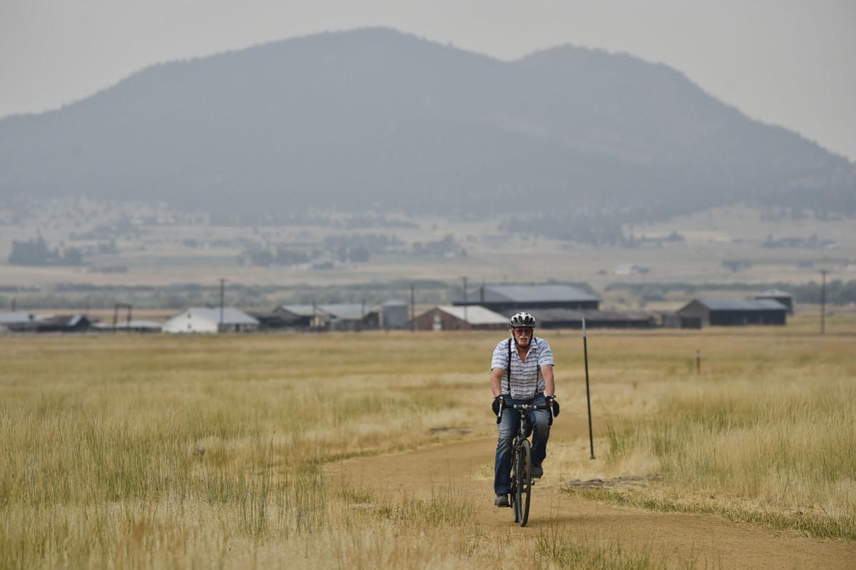 A bicyclist rides through Ten Mile Creek Park