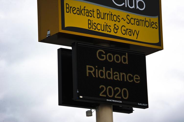 A sign outside the Breakfast Club reads "Good Riddance 2020" on Thursday.