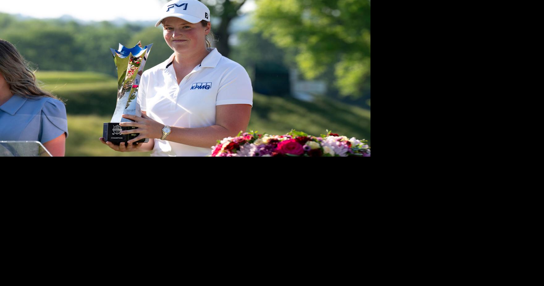 Lottie Woad, of Farnham, England, holds the trophy after winning the LPGA Kroger Queen City Championship fourth round at
