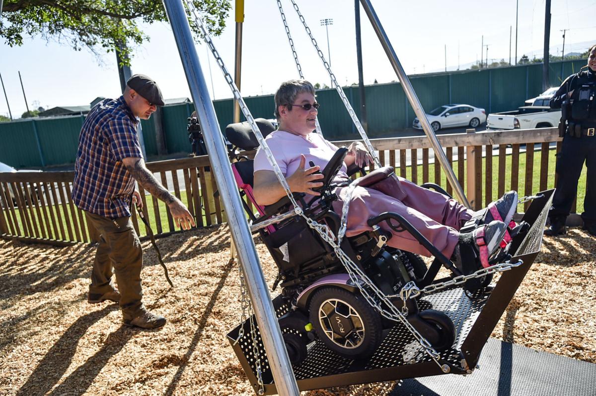 Theresa Gardner gets a push in a new wheel chair capable swing