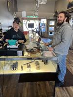 Savannah Brown weighs out a purchase for medical marijuana customer Corey Baker