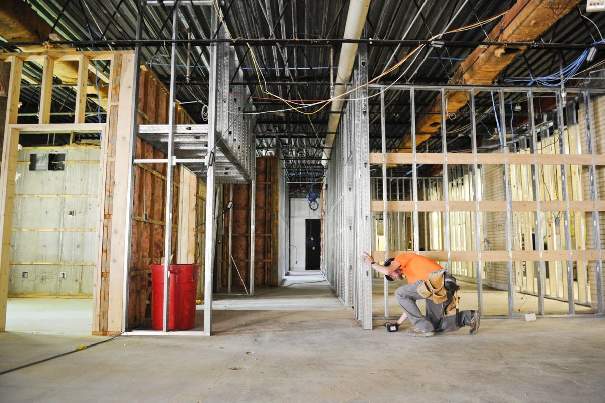 A contractor works on Capital High School main office Thursday.