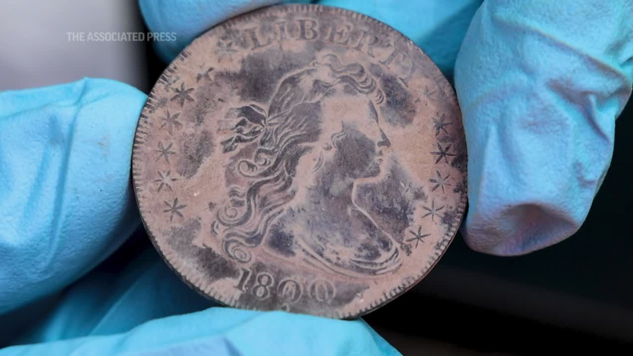 Coins hidden in the mud of a West Point time capsule