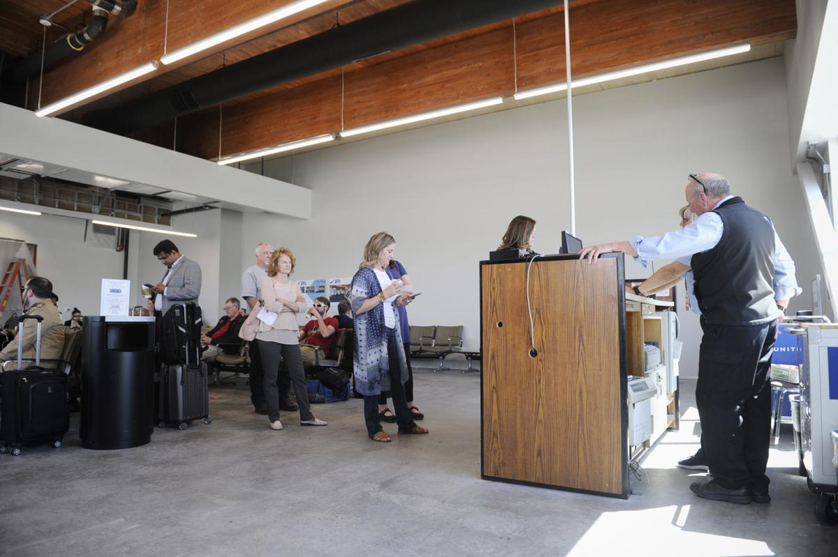 Passengers wait in line at the Helena Regional Airport