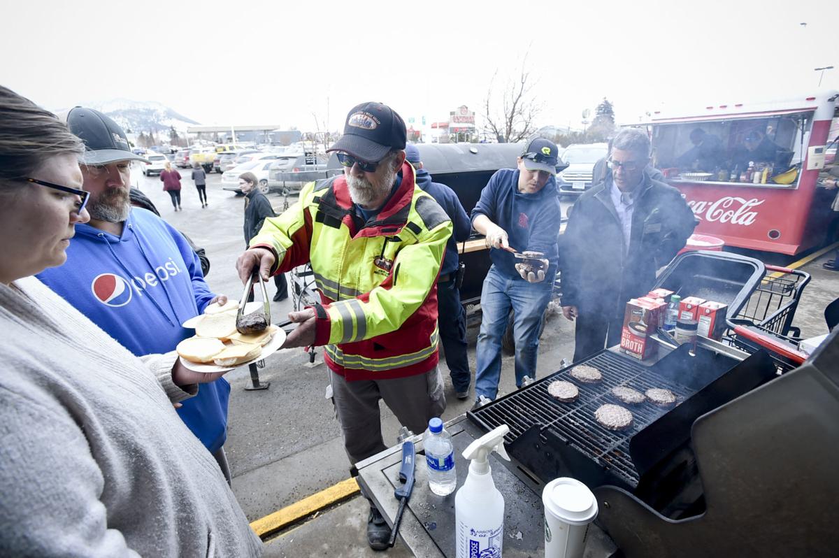 Helena area volunteer firefighters serve hamburgers and hot dogs Wednesday