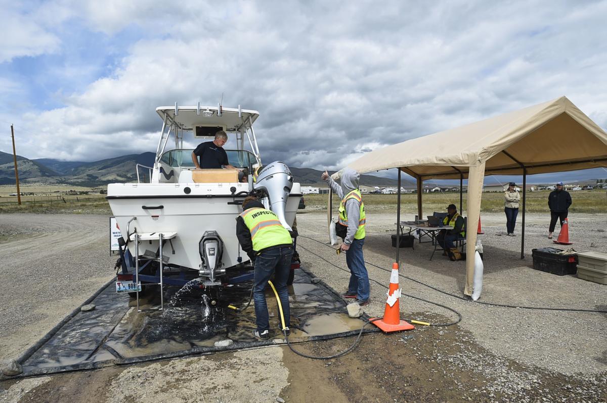 A boat from Wyoming is inspected and decontaminated at the Canyon Ferry decontamination station