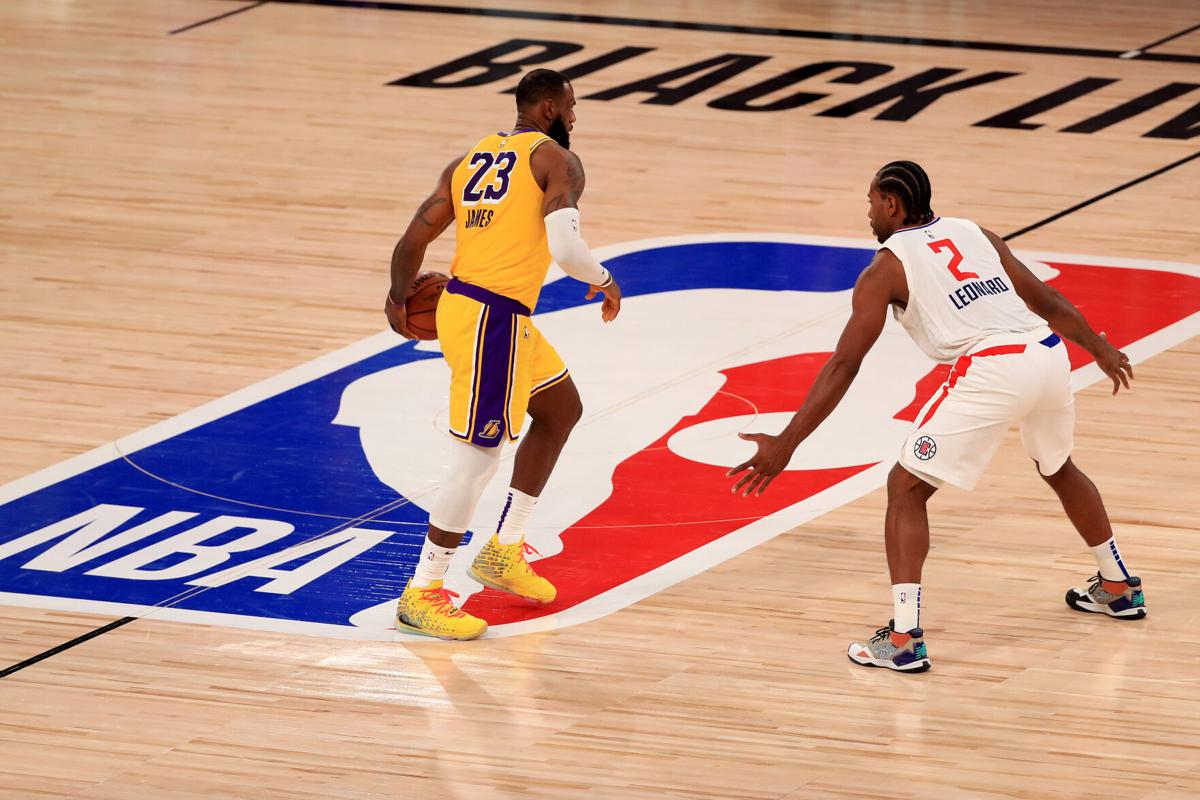LAKE BUENA VISTA, FLORIDA - JULY 30: LeBron James #23 of the Los Angeles Lakers dribbles the ball against Kawhi Leonard #2 of the LA Clippers during the third quarter of the game at The Arena at ESPN Wide World Of Sports Complex on July 30, 2020 in Lake Buena Vista, Florida.