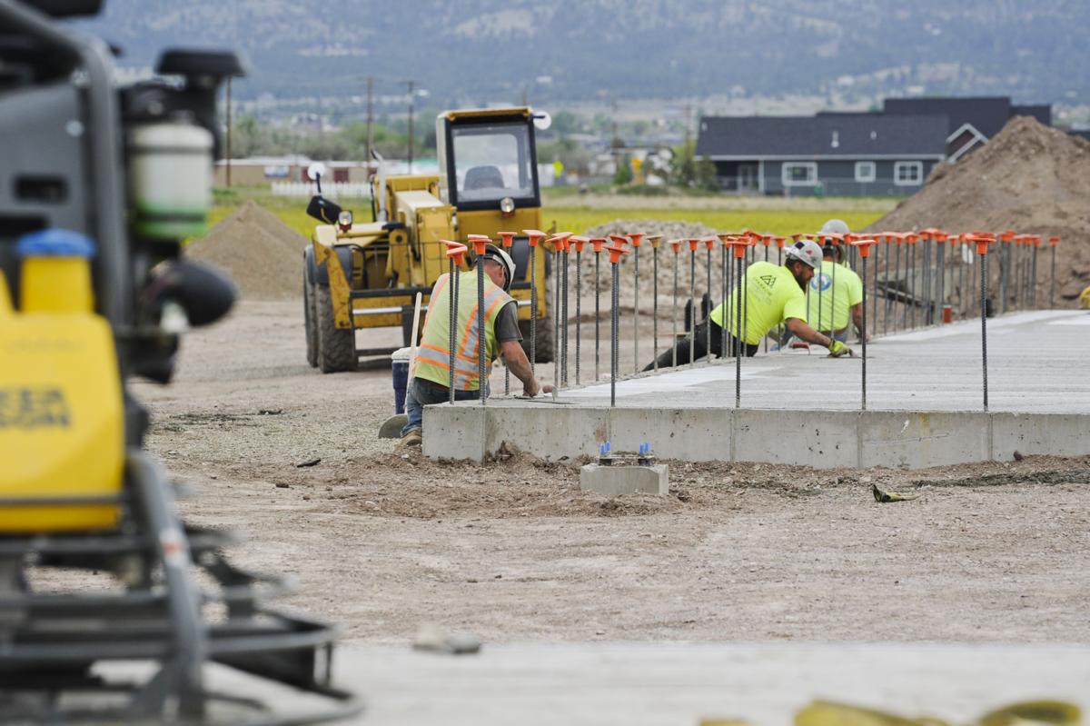 Concrete workers finish the foundation for the new Valley Ace Hardware store adjacent to Bob's Valley Market Friday.