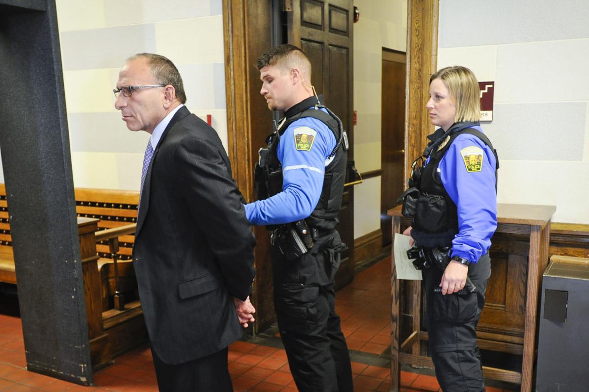 Gregg Trude is led from the Lewis and Clark County Courthouse