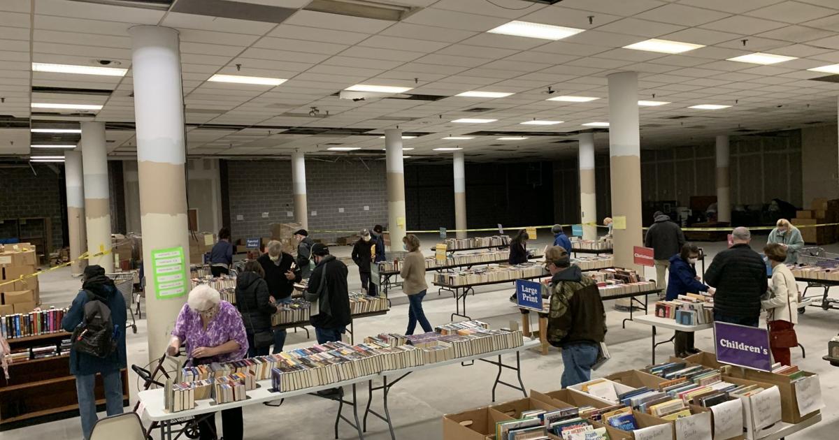 Readers fill their carts at Decatur library's used book sale