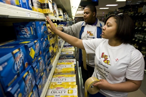 Students slap stickers on booze to remind shoppers of underage  