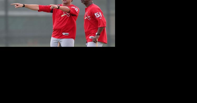 St. Louis Cardinals assistant coach Willie McGee (51) signs a