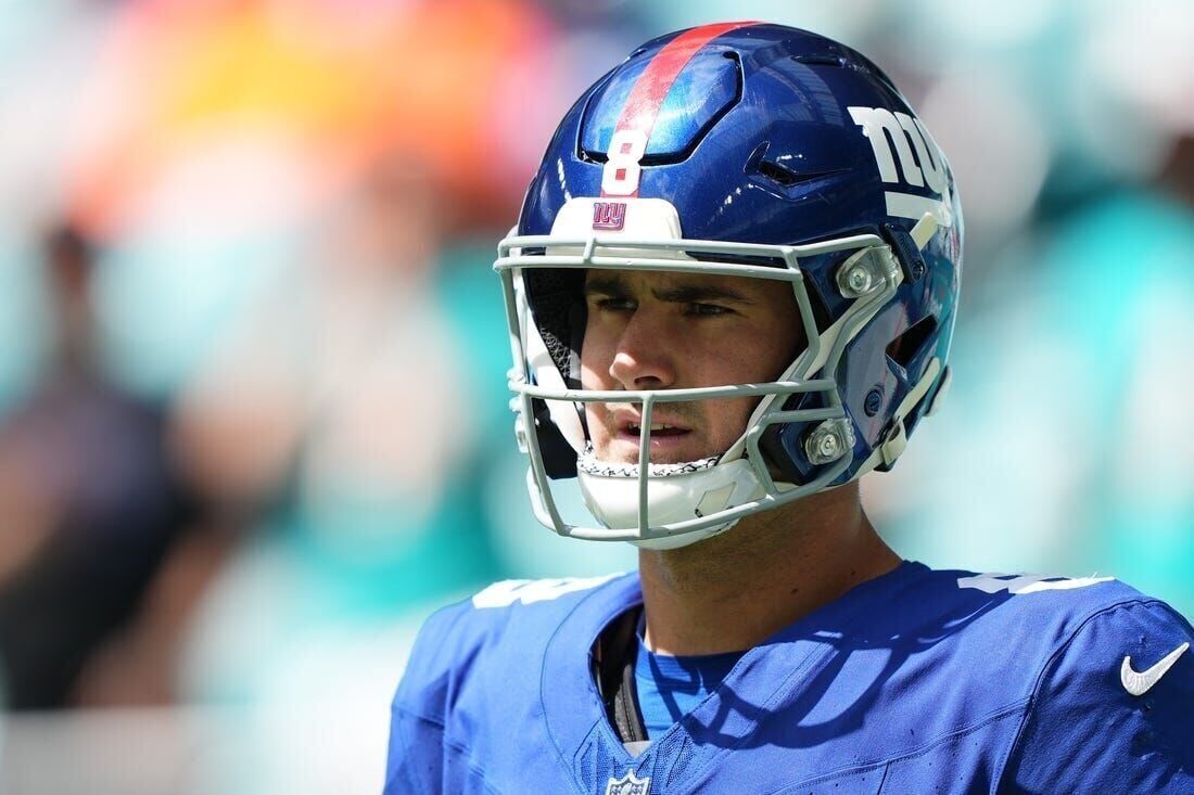 Teammates tip their helmets to Daniel Jones