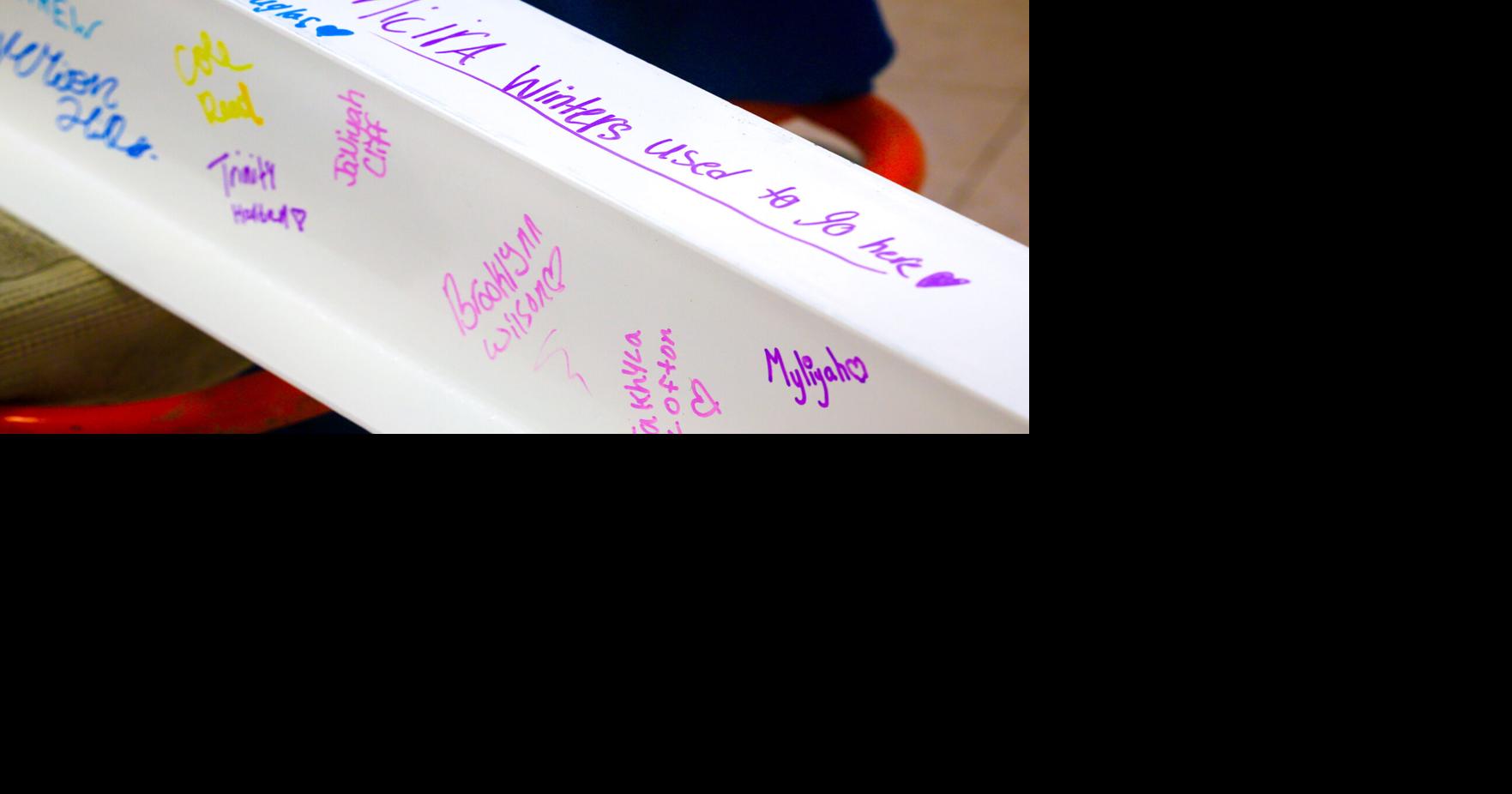 Decatur students sign a Dansby Magnet School beam