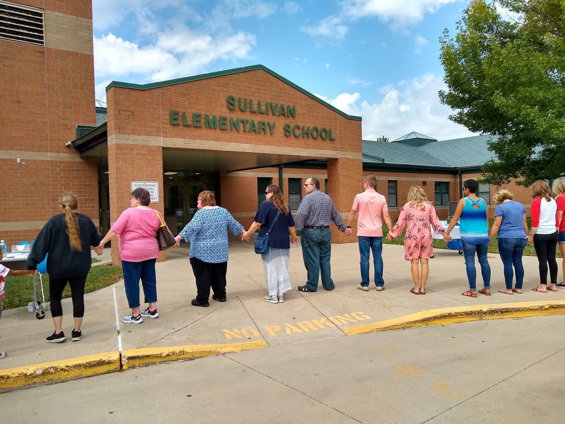 Residents link hands, encircle Sullivan school to show support