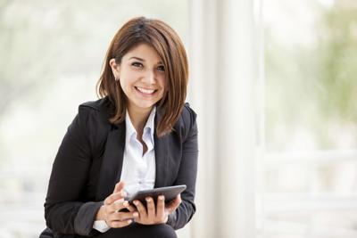 Happy businesswoman with a tablet
