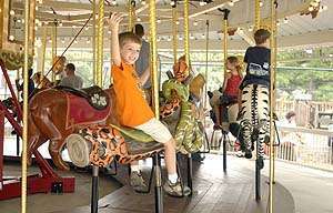 WILD RIDE: Zoo patrons take a spin on new carousel 