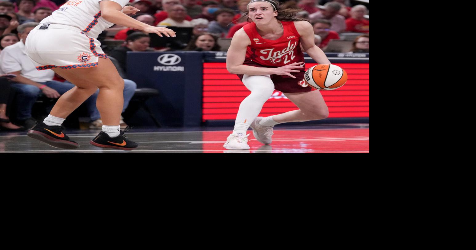 Connecticut Sun guard Charlisse Leger-Walker (4) defends Indiana Fever guard Caitlin Clark (22) as she looks to shoot during a