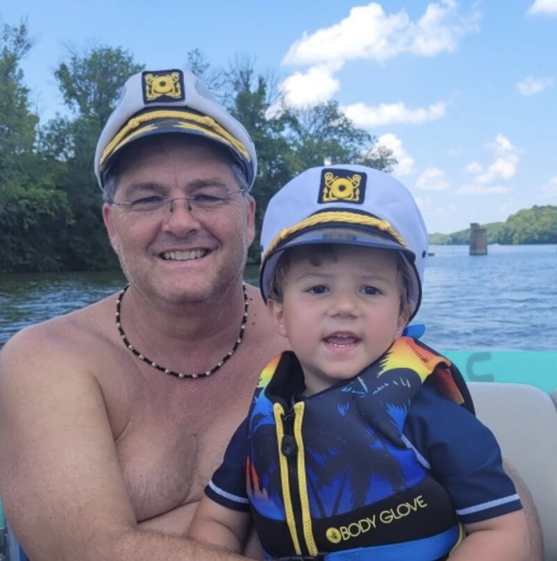 Image of Boy and Dog with Miniature Ship on Lakeshore, The Captain