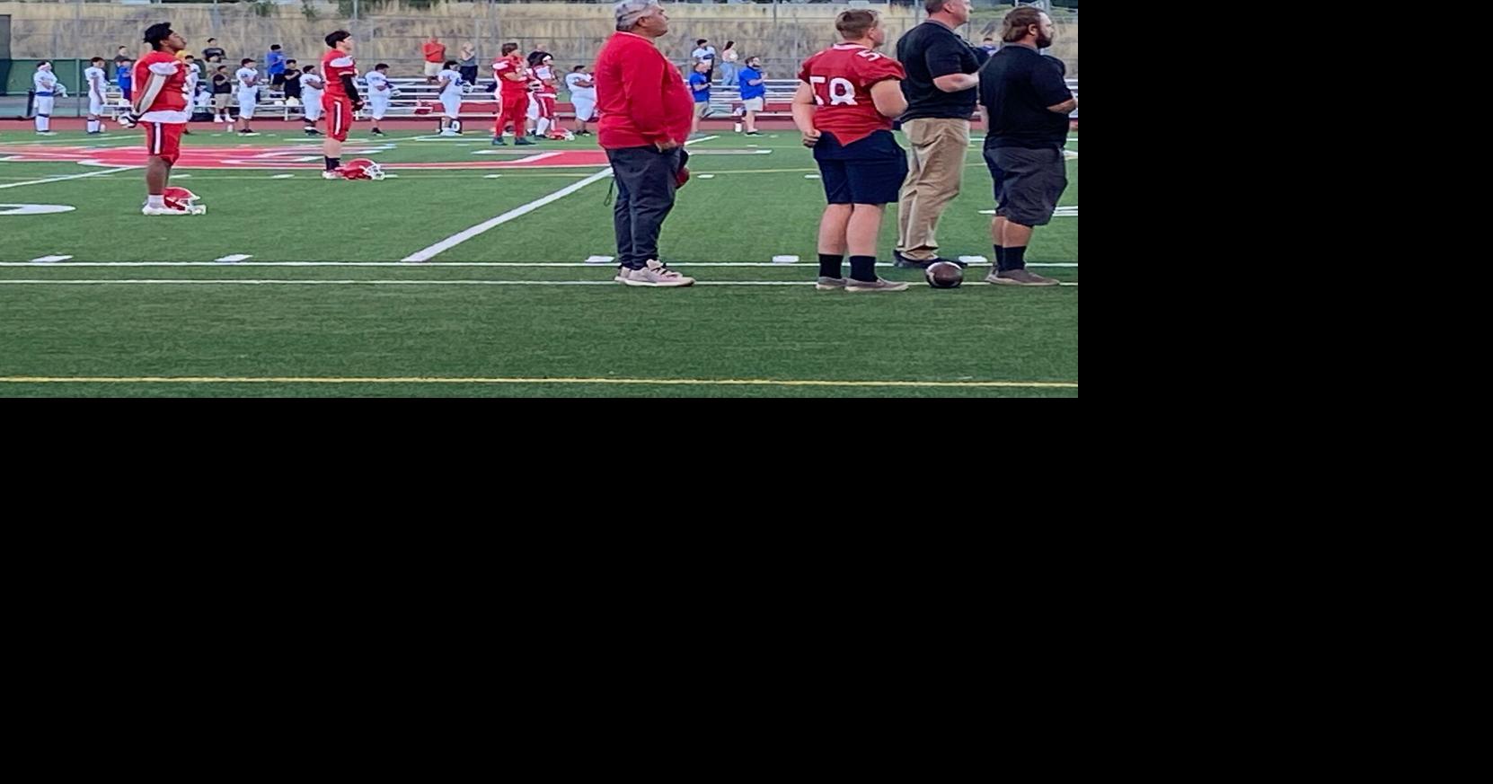 Klamath Union players and coaches salute the flag