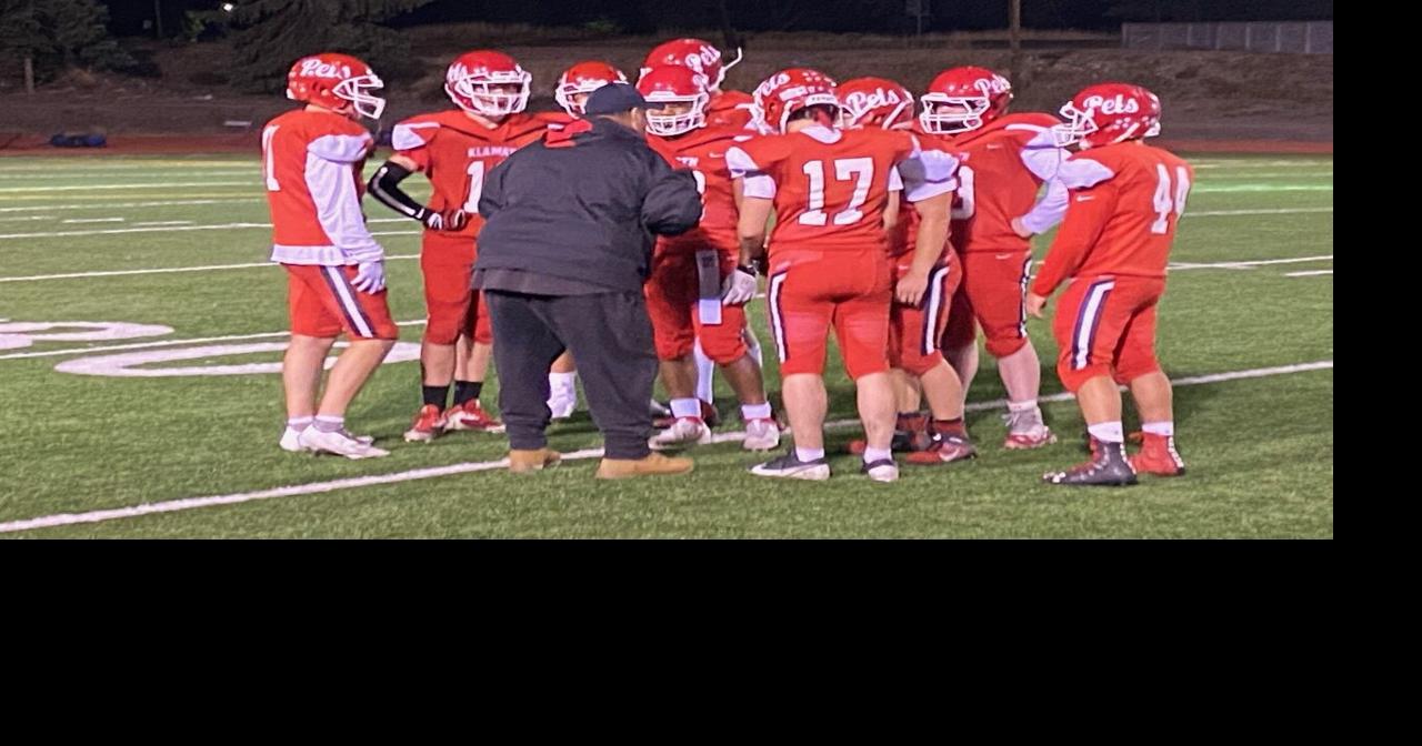 Coach Tom Smith huddles with KU team