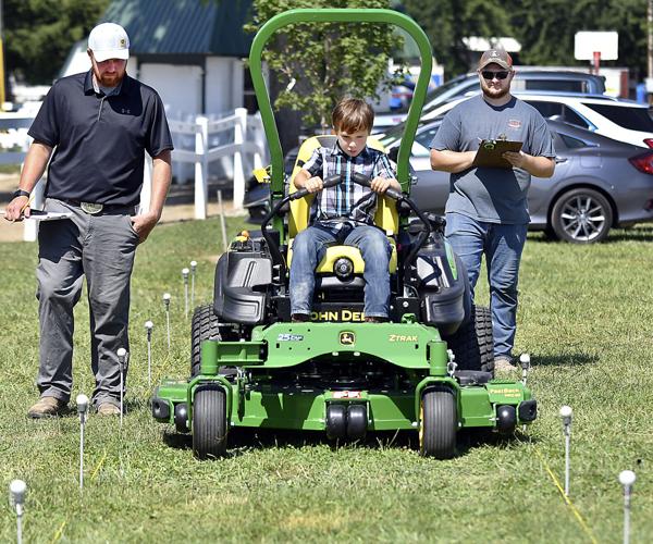 4H members weave their way through tractor driving obstacle course