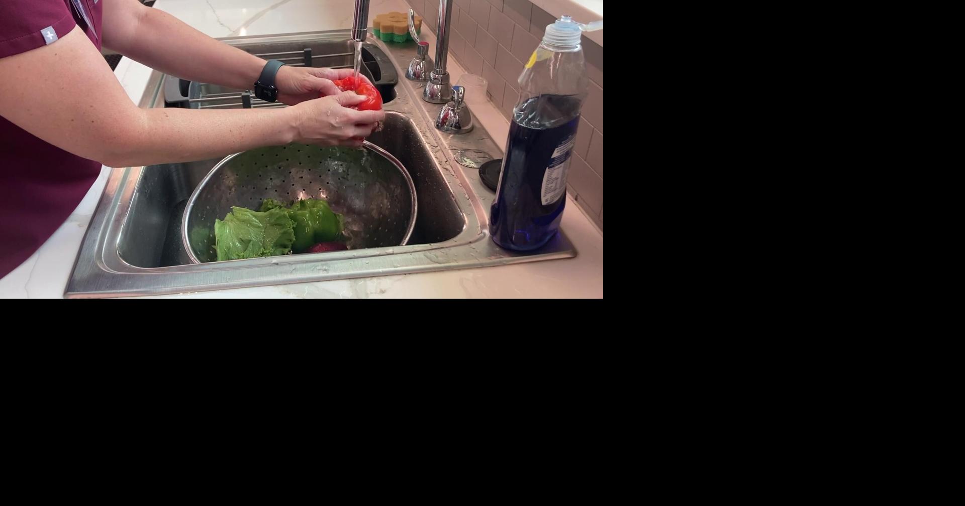 Registered dietitian demonstrates how to wash fruits and veggies