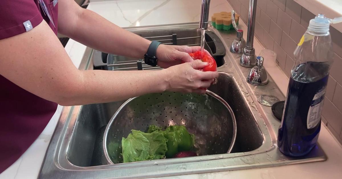 Registered dietitian demonstrates how to wash fruits and veggies