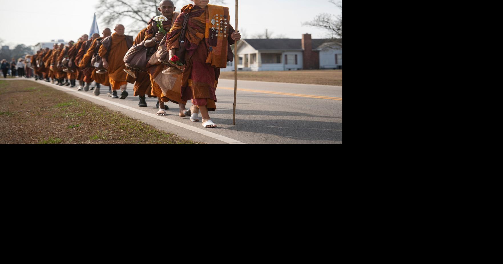 Photos of monks and rescue dog as they finish cross-country peace walk in Washington, DC