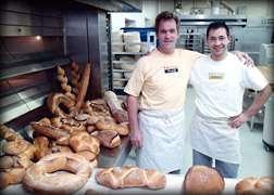 Bit of Swiss Bakery owner Tim Foley (left) stands with Didier Rosada